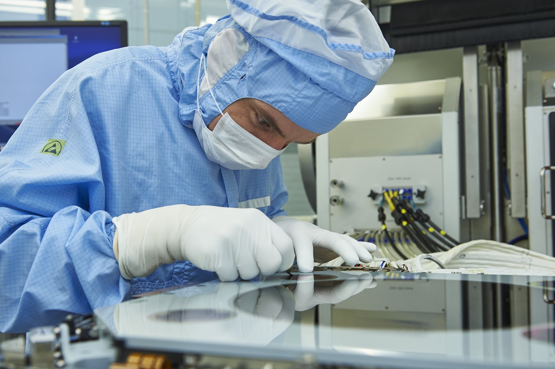 employees in cleanroom suits working in cleanroom