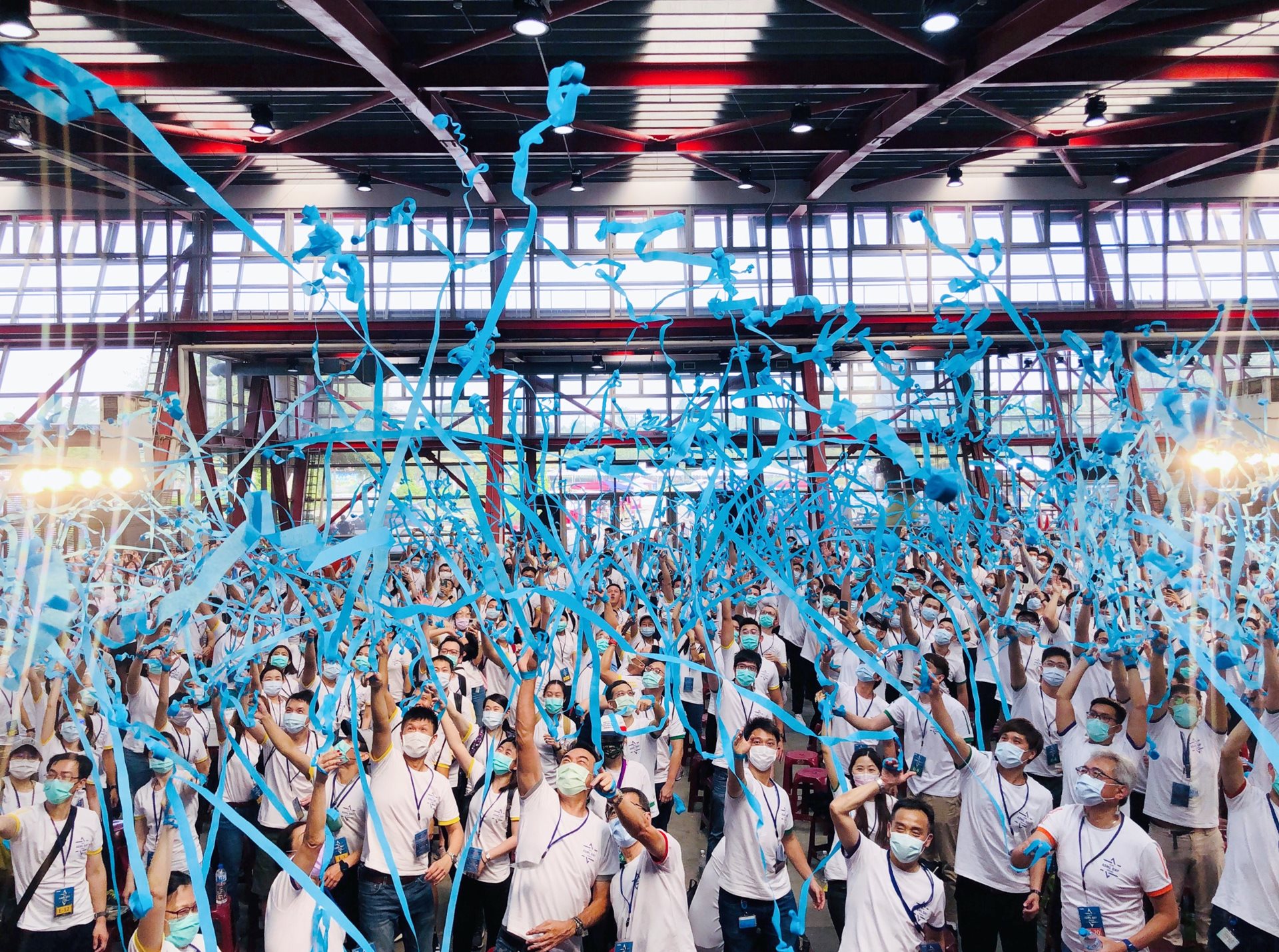 a group of employees from Taiwan let off blue streamers a group of employees from Taiwan let off blue streamers