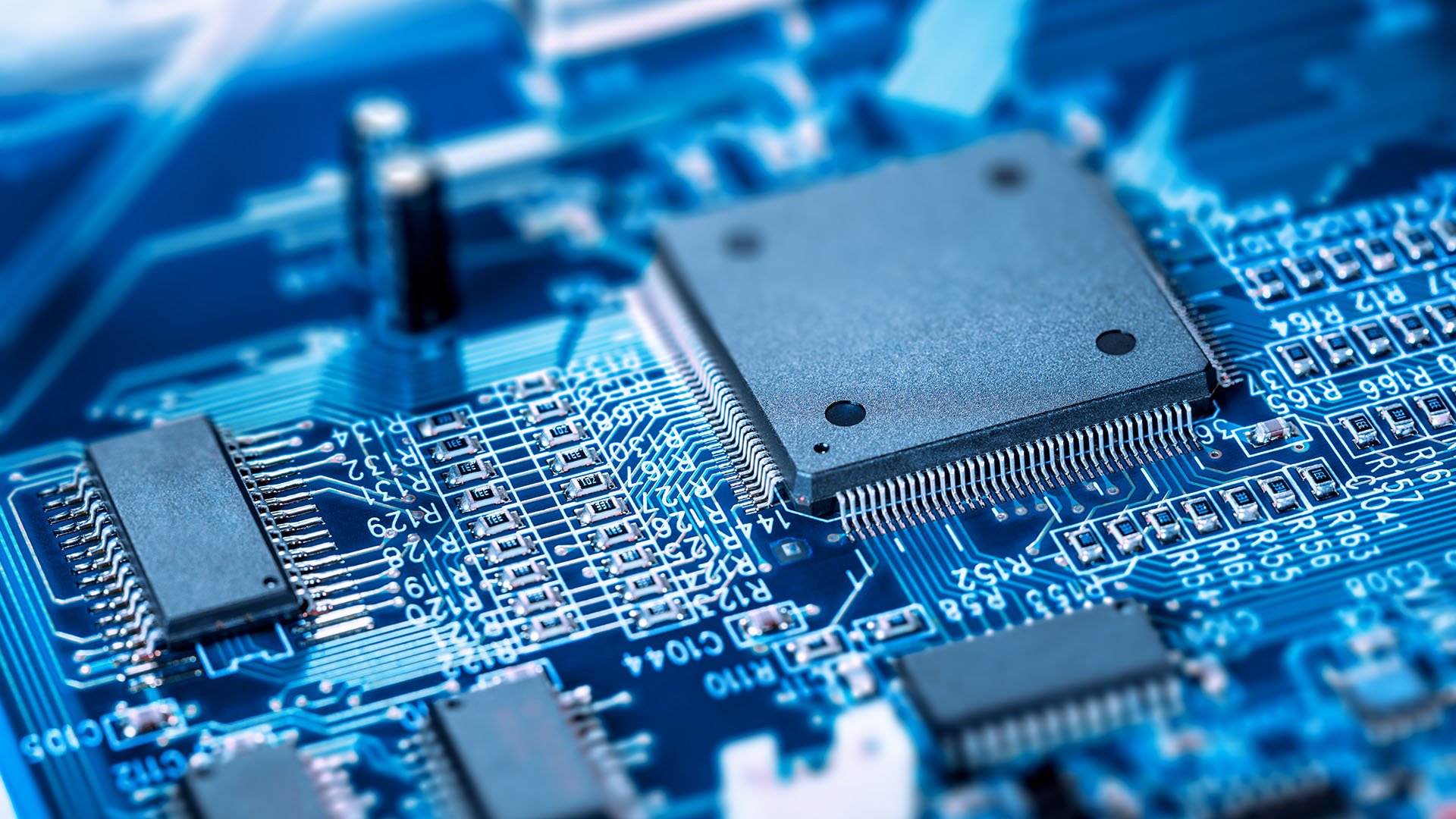 A close-up of a motherboard and circuit board with a microprocessor chip embedded. A close-up of a motherboard and circuit board with a microprocessor chip embedded.
