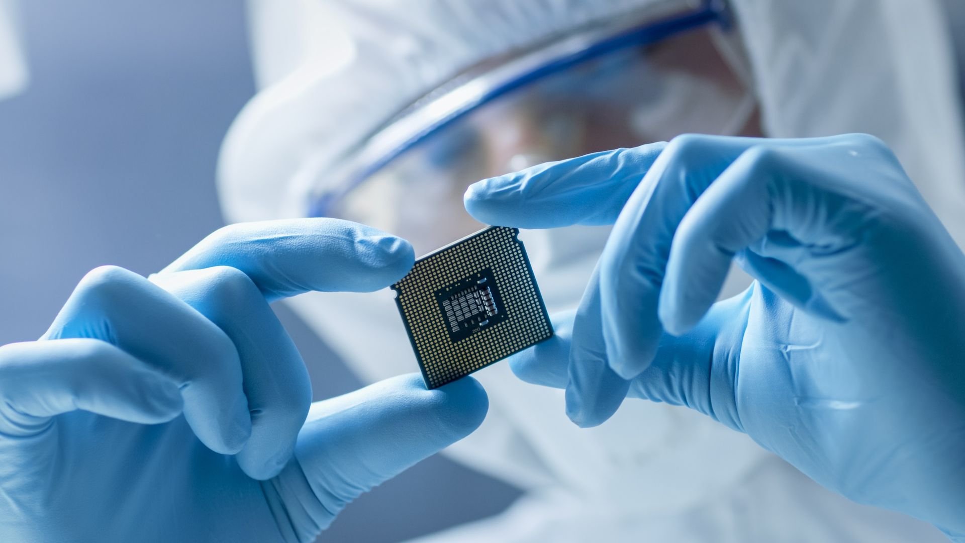 Engineer holds microchip Engineer holds microchip