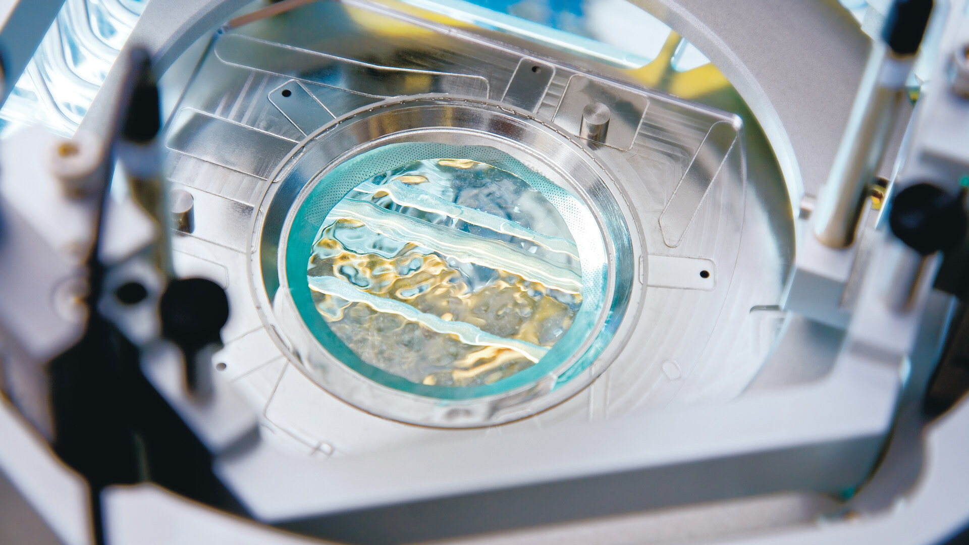 A close-up picture of a layer of water between our lithography system’s optics and a silicon wafer. A close-up picture of a layer of water between our lithography system’s optics and a silicon wafer.