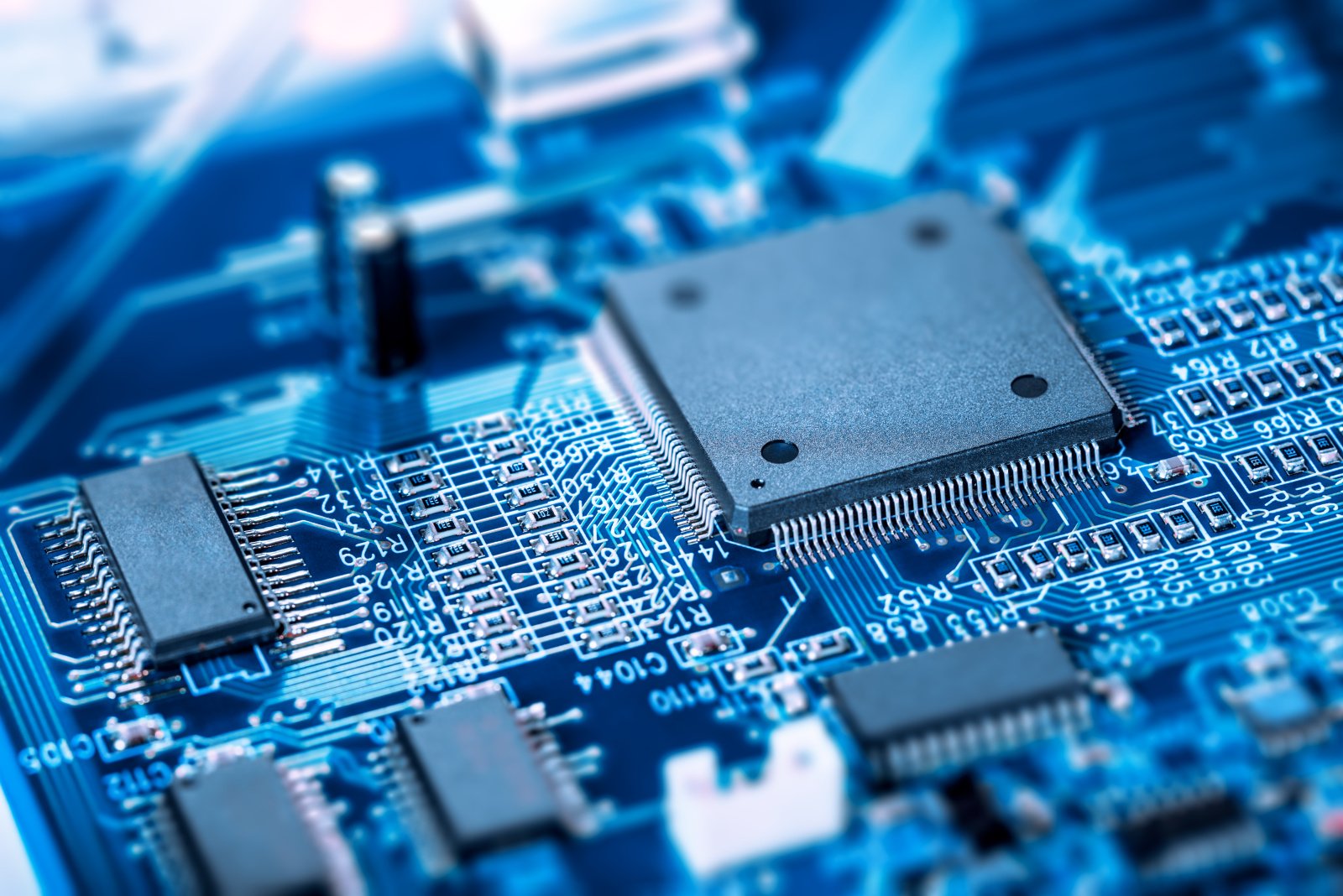 A motherboard with an embedded chip, showing circuits and connections. A motherboard with an embedded chip, showing circuits and connections.
