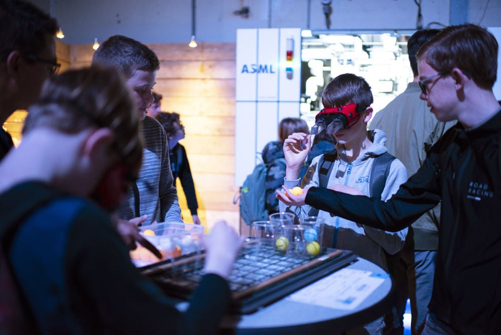 Young people wearing virtual reality googles interact with a technology exhibition at Night of the Nerds.