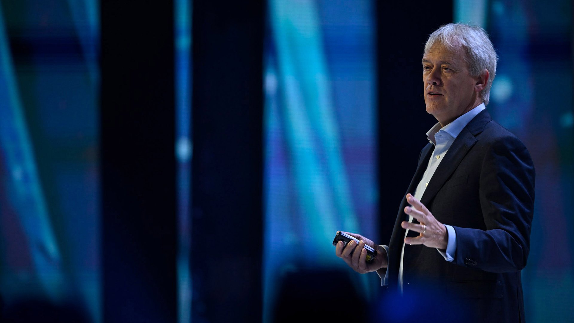 Blond man speaking on a stage Blond man speaking on a stage