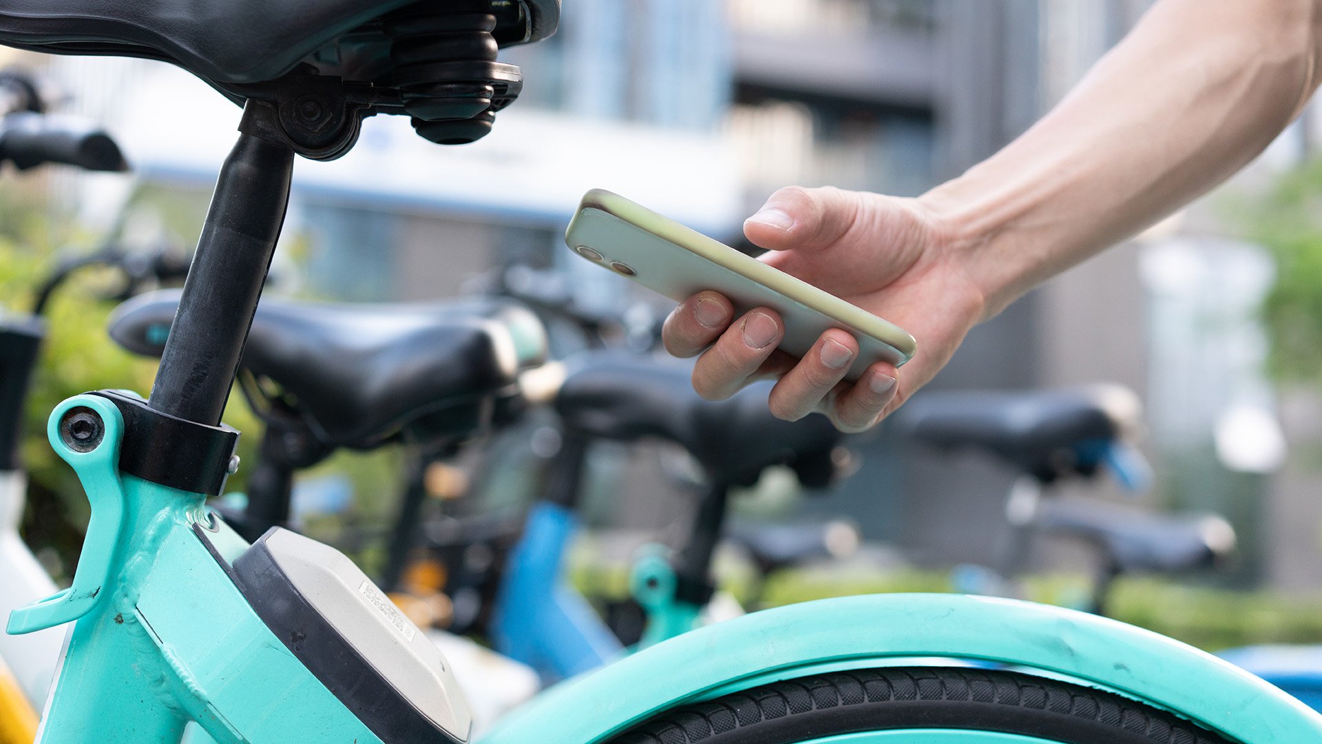 Person with a mobile phone renting a scooter Person with a mobile phone renting a scooter