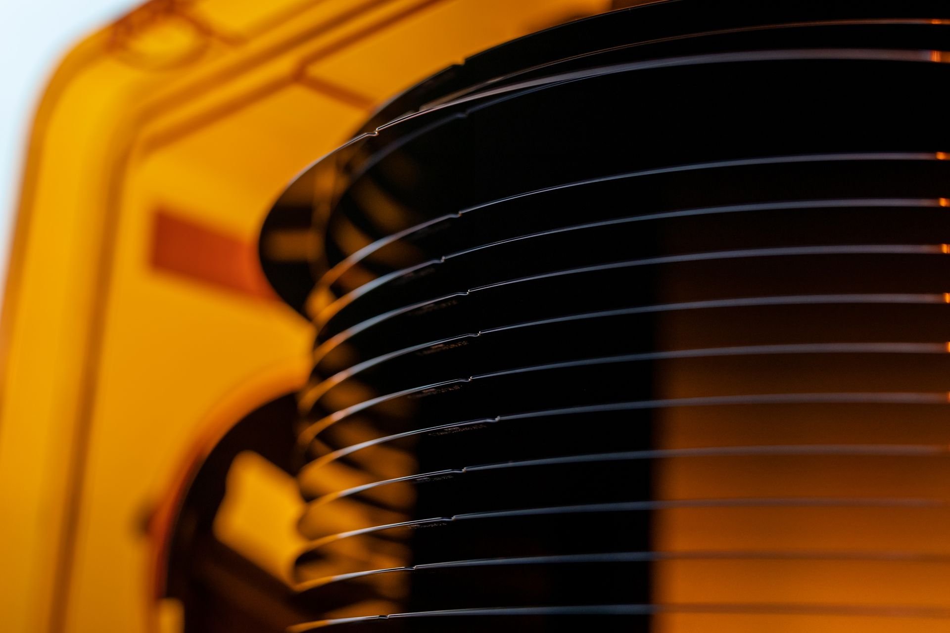 A plastic orange FOUP containing silicon wafers