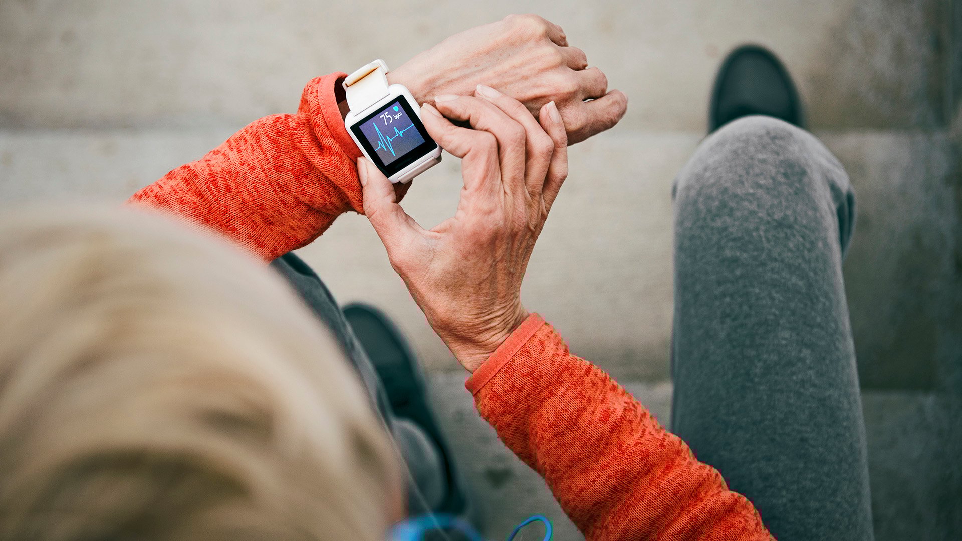 Person looking at heartbeat graph on a smart watch Person looking at heartbeat graph on a smart watch